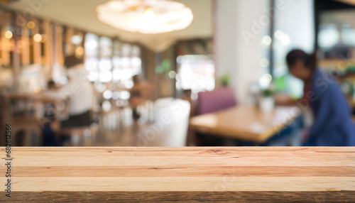 Wood table top with blurred people in cafe as background - can be used for montage or display your products