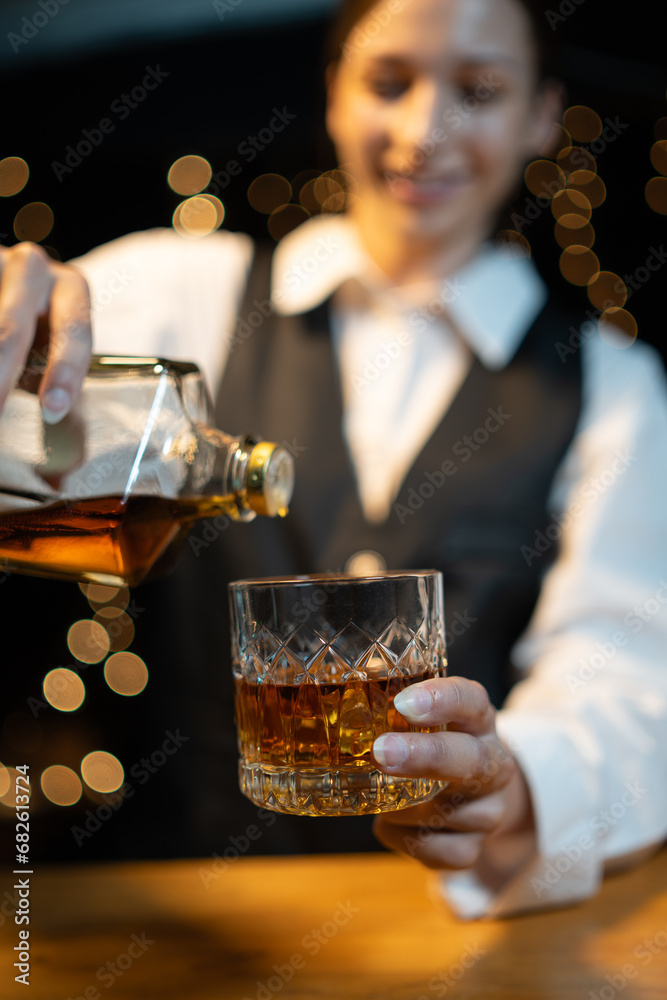 Barwoman pouring whiskey whiskey glass beautiful night