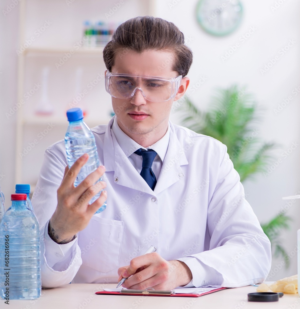 Young male chemist experimenting in lab Young male chemist experimenting in lab