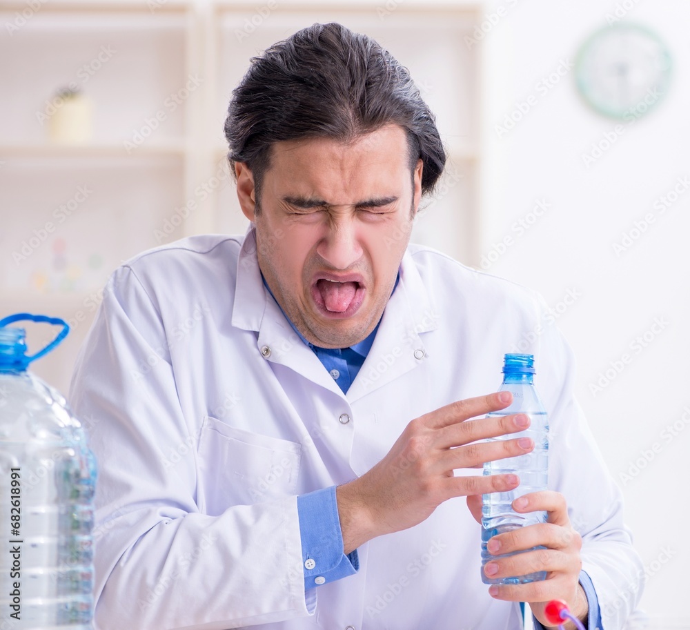 Young male chemist experimenting in lab Young male chemist experimenting in lab