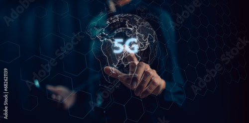 5G technology. Businessman pressing 5g button on virtual screens with hexagons and transparent honeycomb business, technology, internet and virtual reality concept.