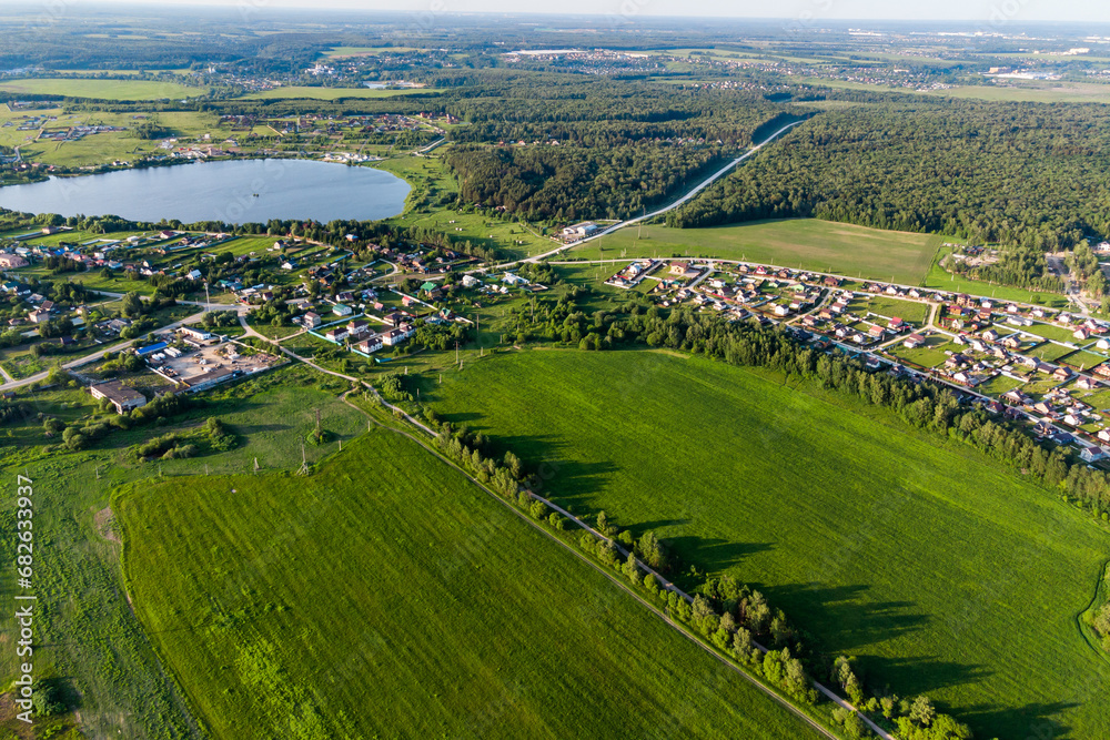 Aerial landscape with a view of the countryside with green fields and village houses