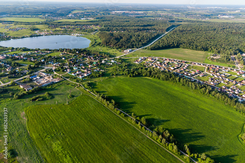 Tableau sur toile Aerial landscape with a view of the countryside with green fields and village ho