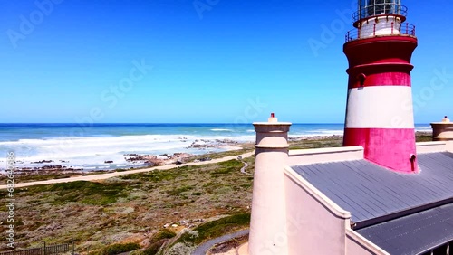 Agulhas lighthouse on treacherous rocky coastline, aerial fly-by