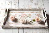Rustic Charm: A weathered wooden tray adorned with distressed white paint, featuring a delicate floral motif in muted pastel hues, perfect for a farmhouse aesthetic.