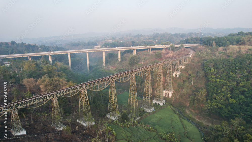 Scenic View of a Passenger Train Passing by Cikubang Bridge Longest Active Train Bridge in Indonesia. 