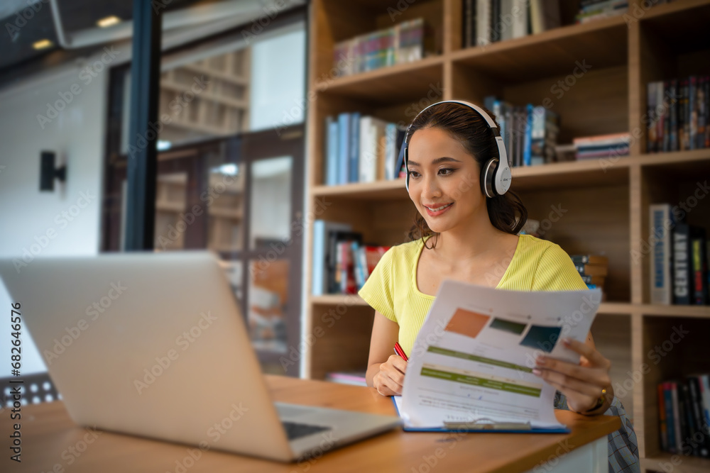 Young woman having video call via computer in the home office.Business video conferencing. Young woman having video call via computer in the home office.Business video conferencing.
