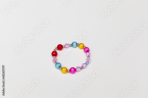 Kids handmade beaded jewelry. Necklaces and bracelets made from multicolored beads and pearls. DIY bracelet beads. Children's needlework. Creativity and hobby. Art activity for kids.