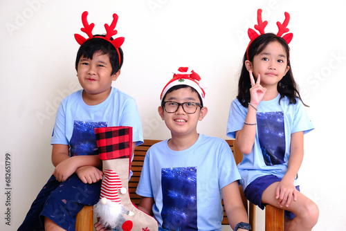 The happiness of children wearing reindeer horns on their heads and presents from Santa Claus photo