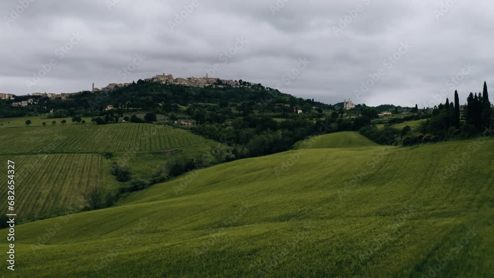 Low drone shot soaring over Italy's rural countryside filled with green fields. Low drone shot soaring over Italy's rural countryside filled with green fields.
