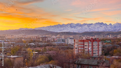 Stunning scenic sunrise in Bishkek city with views of mountain ranges and peaks. Autumn in Kyrgyzstan. Morning in the city. photo