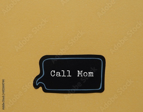 Sticker on yellow background CALL MOM , concept of remind oneself to keep in touch with parents