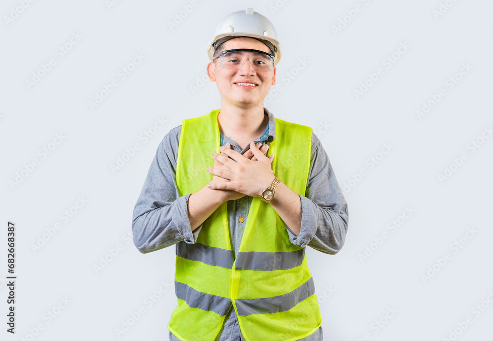 Portrait of young engineer with grateful gesture. Handsome grateful engineer with hands on chest isolated Portrait of young engineer with grateful gesture. Handsome grateful engineer with hands on chest isolated