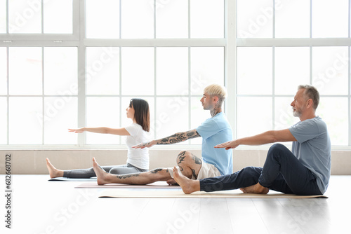Group of sporty people training in gym photo