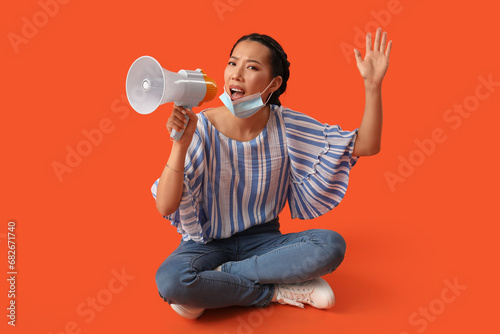 Young Asian woman with mega...