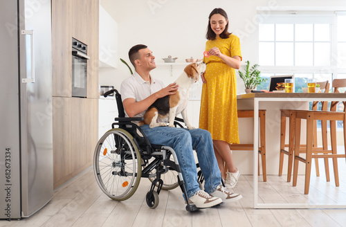 Young man in wheelchair wit...