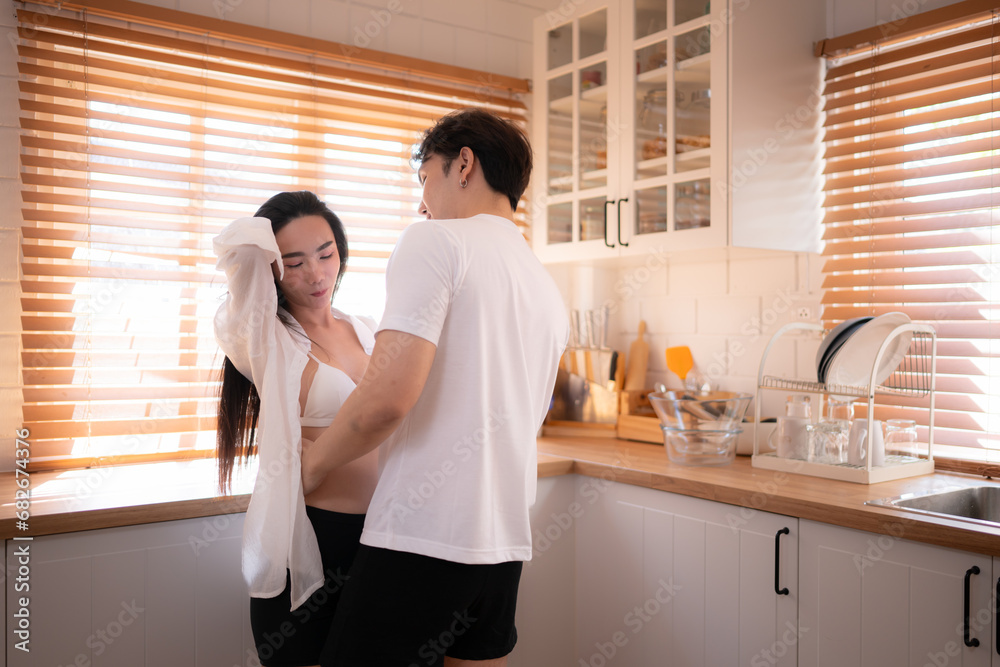 Young asian couple have fun dancing together in the kitchen at home. Happy family concept. Young asian couple have fun dancing together in the kitchen at home. Happy family concept.