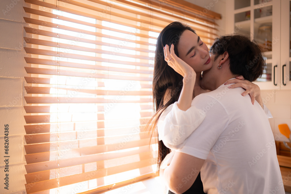Young asian couple show each other affection in the kitchen at home. Happy family concept. Young asian couple show each other affection in the kitchen at home. Happy family concept.
