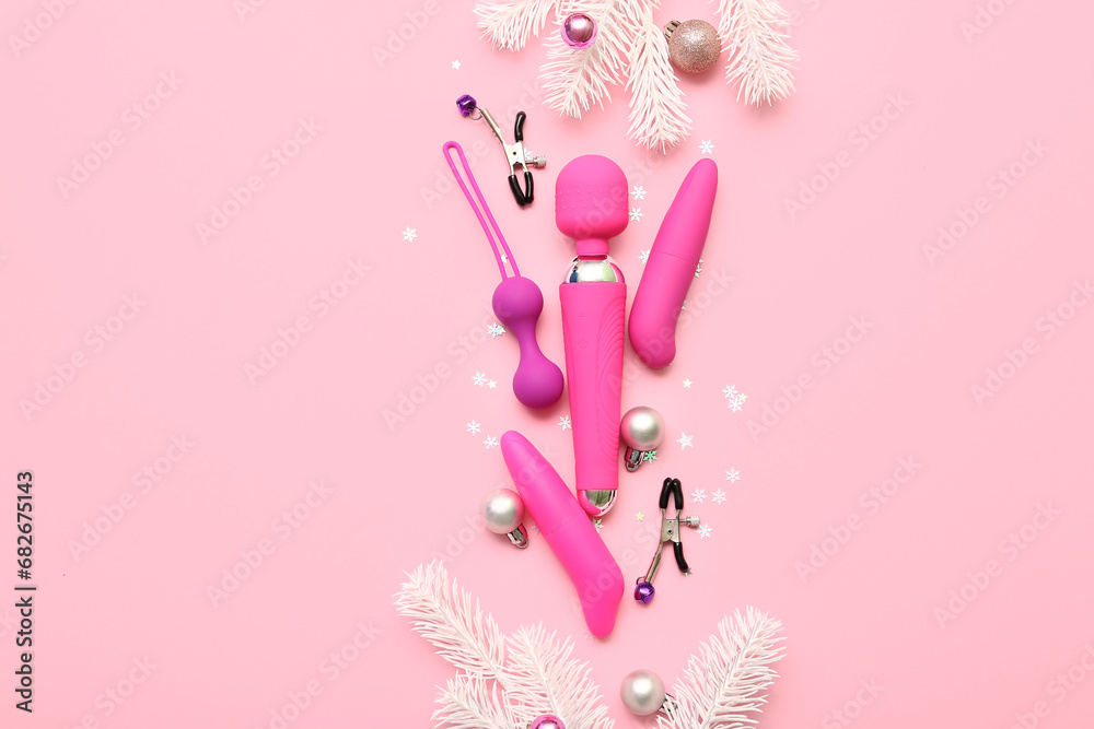 Sex toys and Christmas decor on pink background Sex toys and Christmas decor on pink background