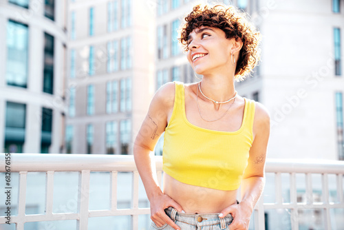 Free Download Young beautiful smiling hipster woman in trendy summer clothes. Carefree woman with curls hairstyle, posing in the street at sunny day. Positive model outdoors. Cheerful and happy - GFXLoad