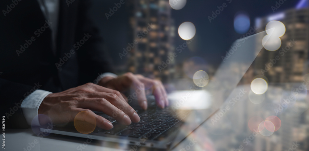 man hand working on a laptop, bokeh blurred at night For text copy space, business concept. man hand working on a laptop, bokeh blurred at night For text copy space, business concept.