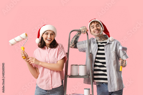 Young couple in Santa hats ...