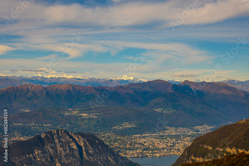 Aerial View over Beautiful Mountainscape with Snow Capped Mountain and Lake Lugano and City of Lugano in a Sunny Day in Ticino, Switzerland.