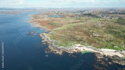 Wide aerial Coral Beach in Ballyconneely, clear ocean waters and rural development in the distance photo