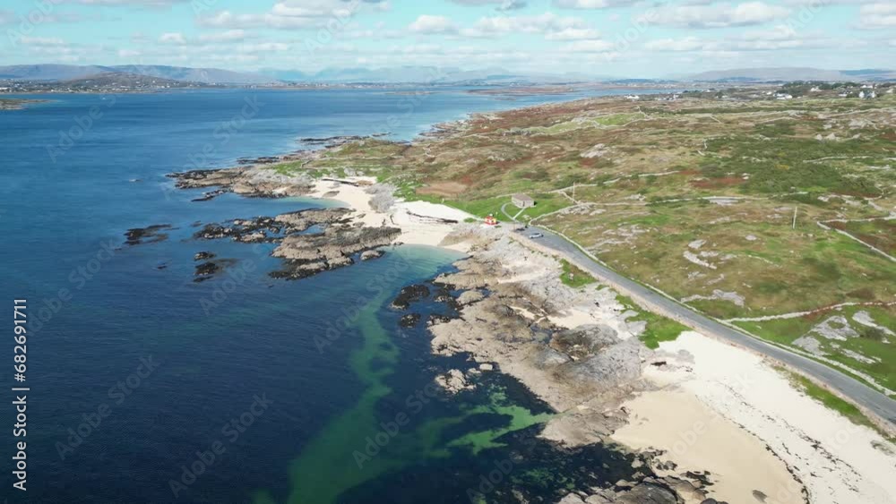 Drone shot of Coral Beach in Ballyconneely, aerial footage or road on coastline and clear ocean waters Drone shot of Coral Beach in Ballyconneely, aerial footage or road on coastline and clear ocean waters