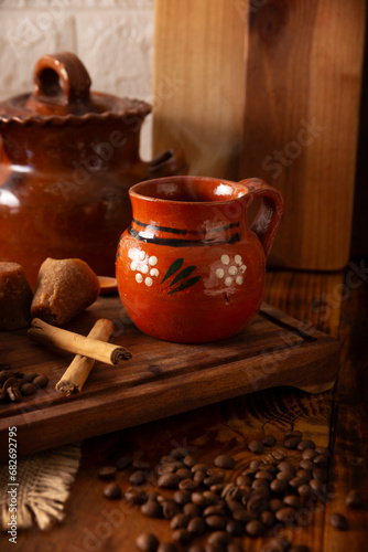 Cafe de Olla, Mexican-style coffee prepared with roasted and ground coffee beans, cinnamon and piloncillo. Traditional recipe prepared in a clay pot and served in a clay cup called a jarrito.