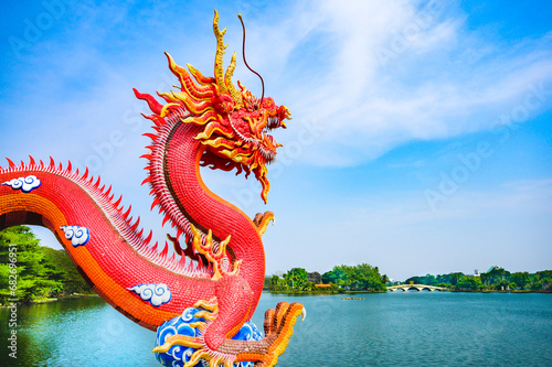 Red dragon statue and lake view in Nakhon Sawan Province photo