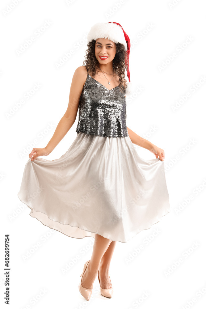 Beautiful African-American woman in Santa hat on white background. New Year celebration Beautiful African-American woman in Santa hat on white background. New Year celebration