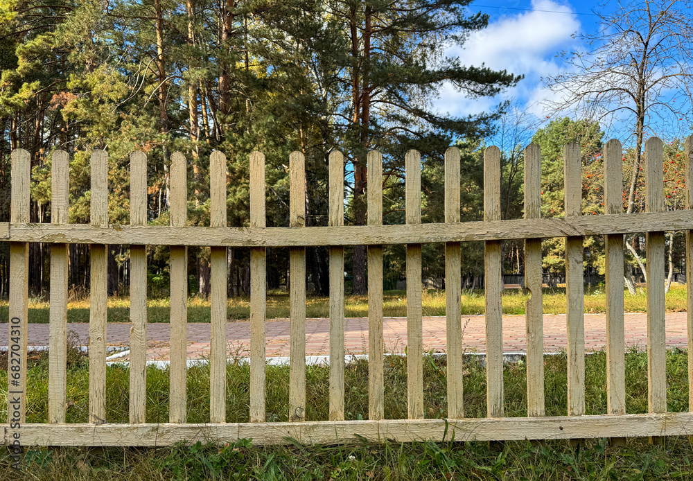 Yellow wooden fence in nature. Background Yellow wooden fence in nature. Background