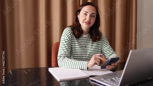 Smiling friendly businesswoman talking with a friend while answering texting her phone