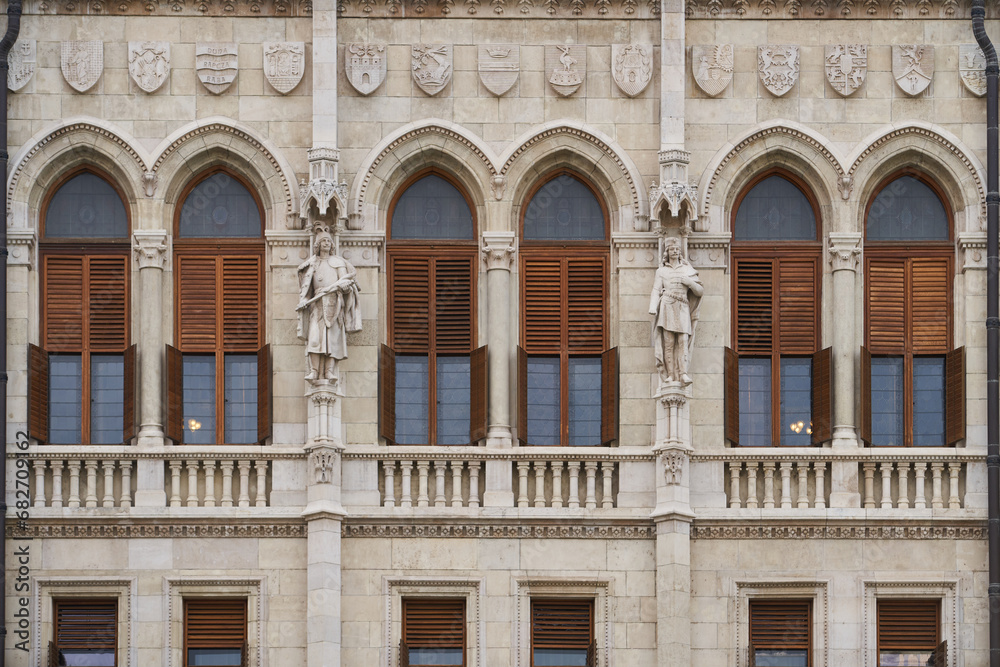 Statues and bas relief on the exterior of Hungarian Parliament Building (Hungarian: Országház). Budapest, Hungary - 7 May, 2019