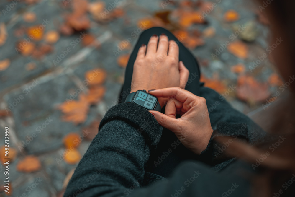 Business woman Looking at smart watch In Park online connect Gadget technology Business woman Looking at smart watch In Park online connect Gadget technology