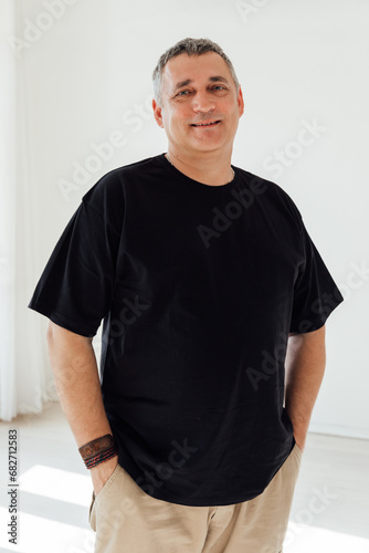 A 50-year-old man in a black t-shirt © dmitriisimakov