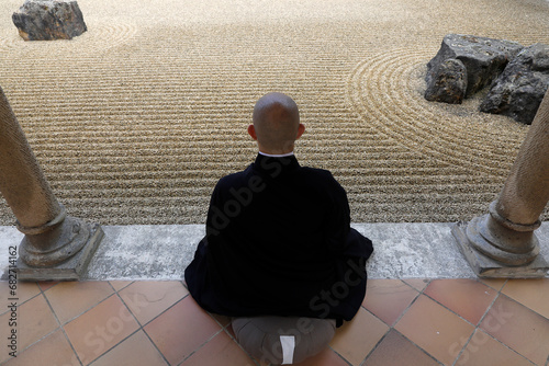 Zen buddhist monk practising zazen (meditation) in Orval trappist abbey's zen garden, Belgium. photo