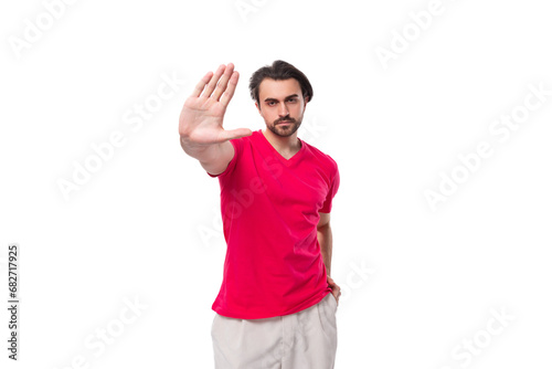 young brunette advertiser man dressed in a red t-shirt with a mockup