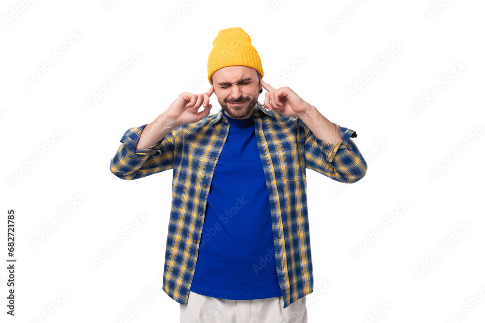 young smart caucasian brunette handsome man with a well-groomed beard and mustache in a plaid shirt is trying to concentrate young smart caucasian brunette handsome man with a well-groomed beard and mustache in a plaid shirt is trying to concentrate