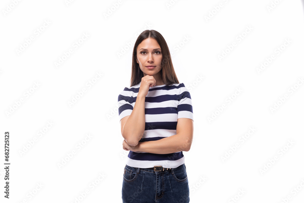 young smart brunette european lady of slim build dressed in a black and white t-shirt on a white background with copy space young smart brunette european lady of slim build dressed in a black and white t-shirt on a white background with copy space