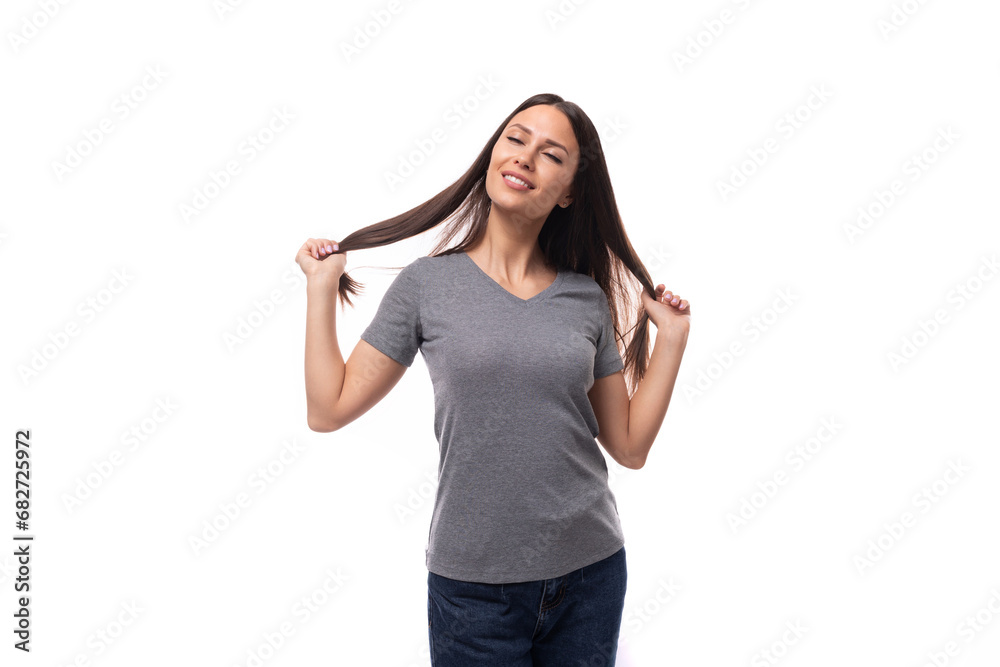 young slim brunette promoter woman with straight long hair dressed in a gray basic t-shirt with print mockup. uniform concept young slim brunette promoter woman with straight long hair dressed in a gray basic t-shirt with print mockup. uniform concept