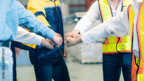 Warehouse staff shaking hands in warehouse. Logistics supply chain and warehouse business concept.