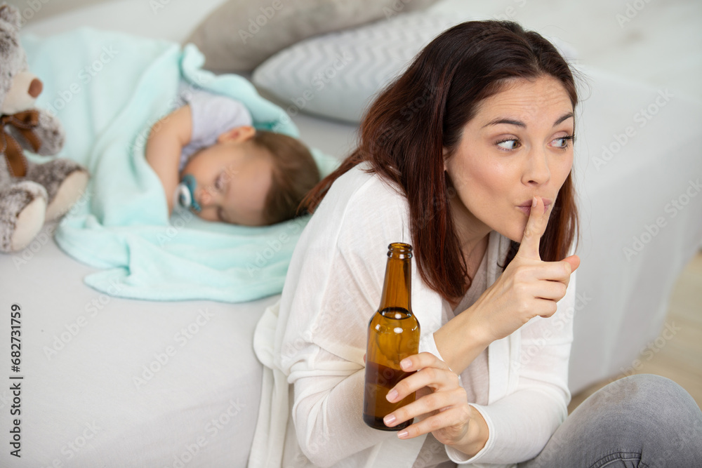 beautiful young mom l showing silence sign while drinking