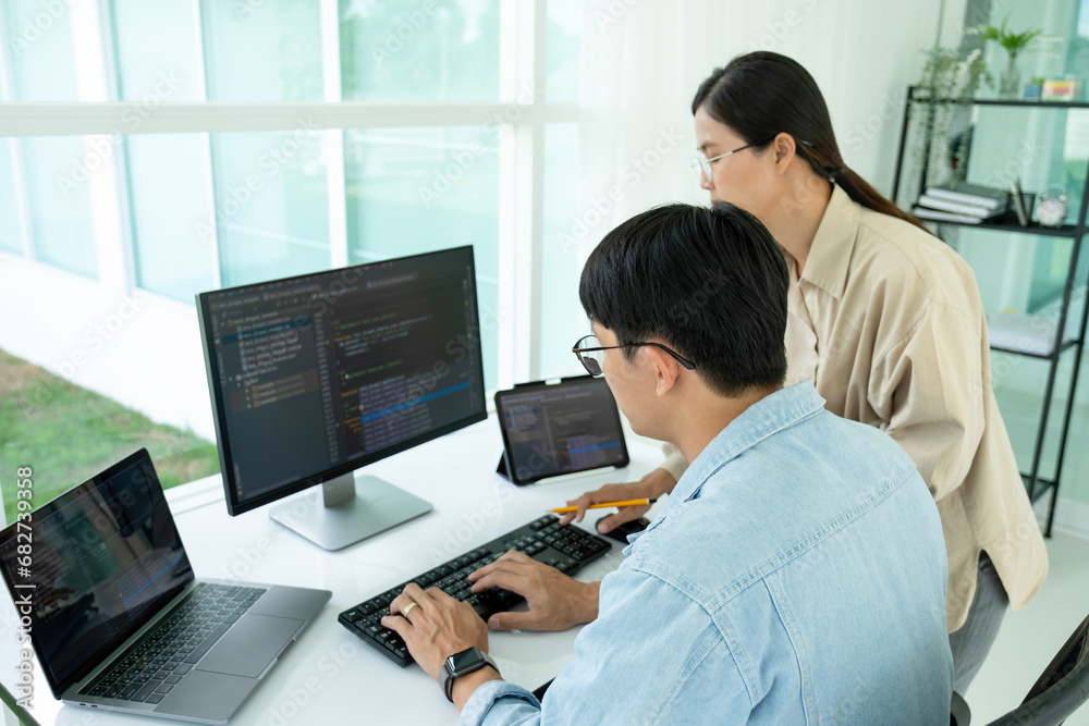 IT programmers working together at office desk. IT programmers working together at office desk.