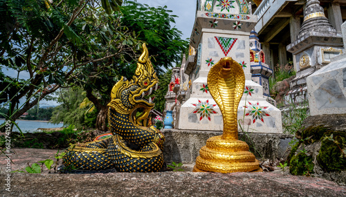 Snake sculptures in a Buddhist cemetery at the Wat Sila Ngu temple in Thailand
