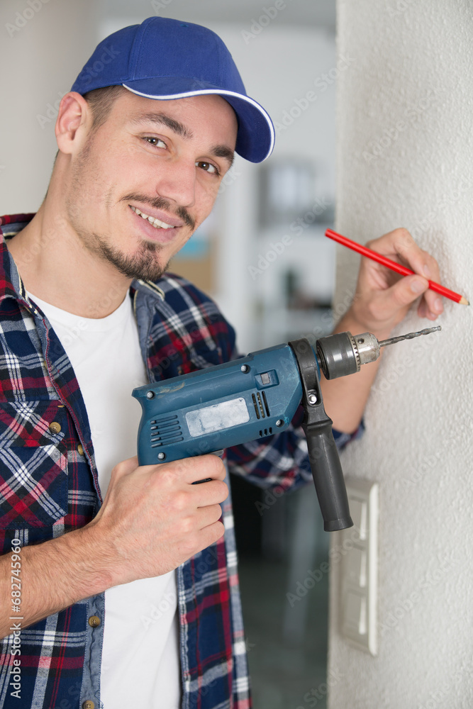close up of young male worker using a drill close up of young male worker using a drill