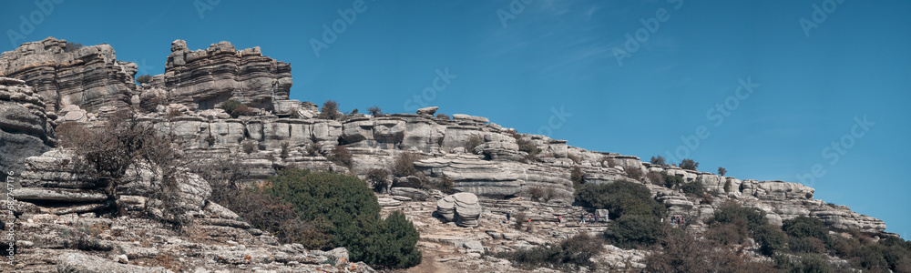 Trekkers Navigating Layered Rock Formations in Torcal de Antequera