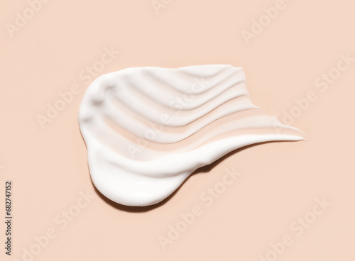 cosmetic smears of creamy texture on a beige background