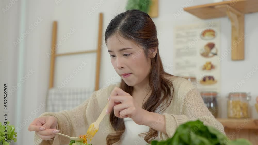 Young asian woman eating healthy food with salad vegetables. Young asian woman eating healthy food with salad vegetables.